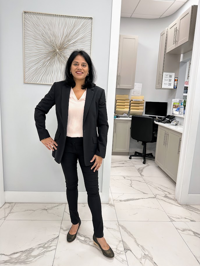 Dr. Prathima Adusumilli standing inside the office