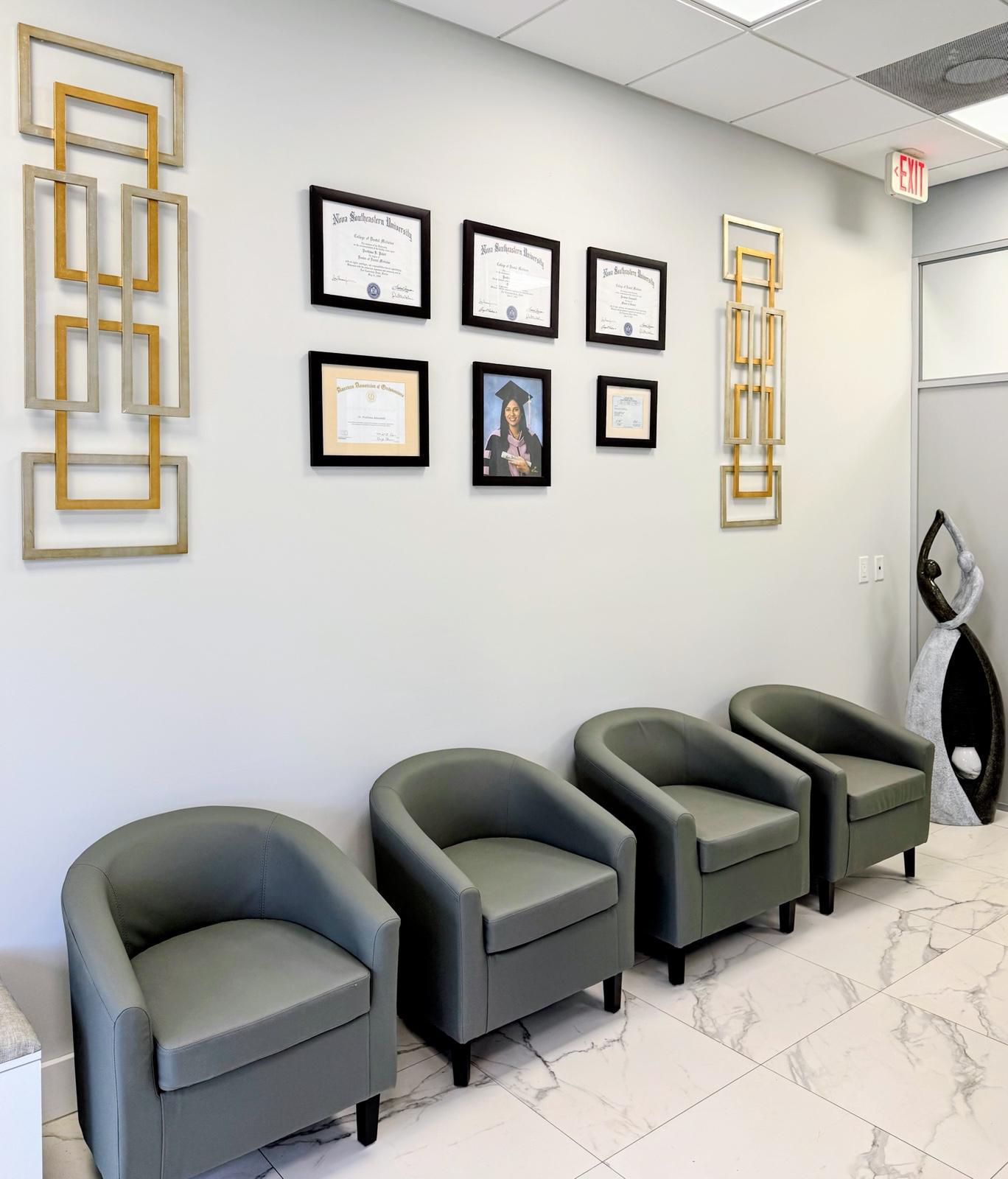 Coral Orthodontics office wall with certificates and chairs